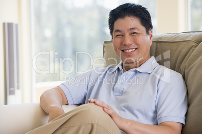 Man sitting in living room smiling