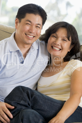 Couple relaxing in living room and smiling