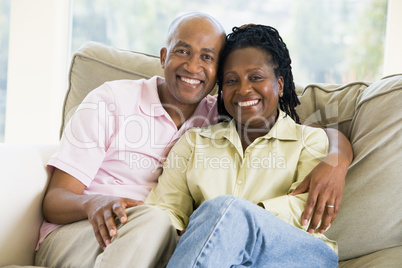 Couple relaxing in living room and smiling