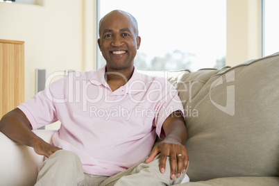 Man sitting in living room smiling