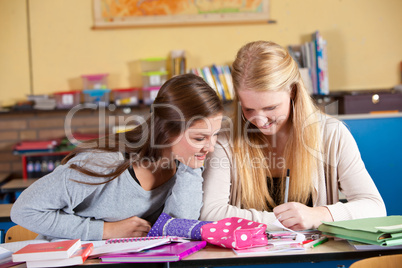 Two schoolgirls in class