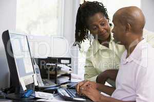 Couple in home office using computer