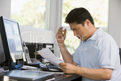 Man in home office using computer