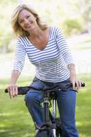 Woman on bike outdoors smiling