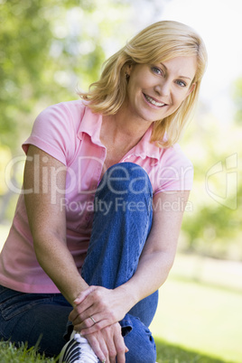 Woman sitting outdoors smiling