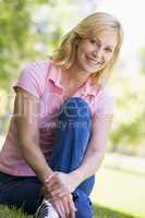 Woman sitting outdoors smiling