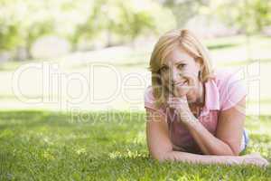 Woman relaxing outdoors smiling