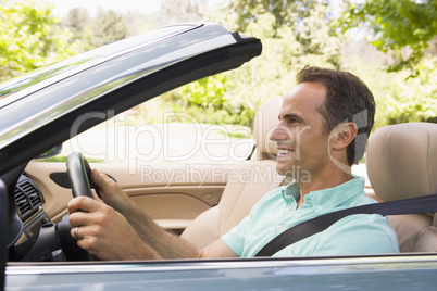 Man in convertible car smiling