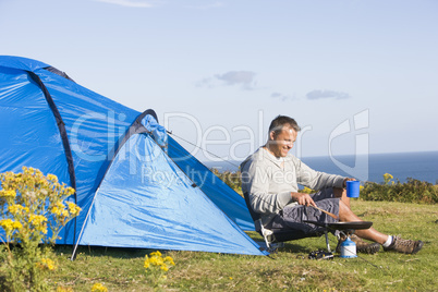 Man camping outdoors and cooking