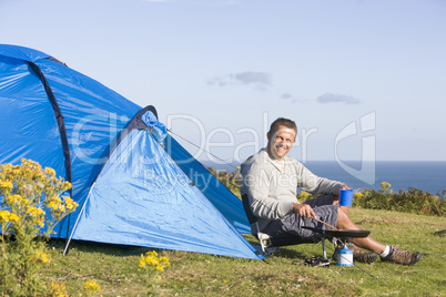 Man camping outdoors and cooking