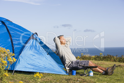 Man camping outdoors and cooking