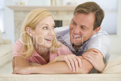 Couple relaxing in living room and smiling