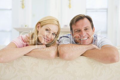 Couple relaxing in living room and smiling