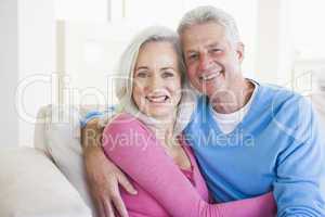 Couple relaxing in living room and smiling