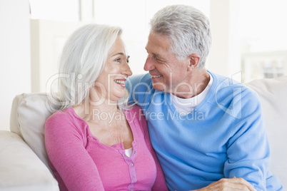 Couple relaxing in living room and smiling