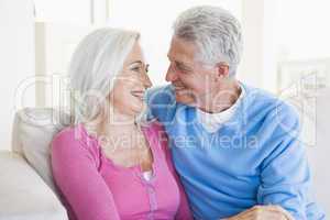 Couple relaxing in living room and smiling