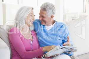 Couple with a magazine smiling