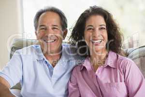 Couple relaxing in living room and laughing