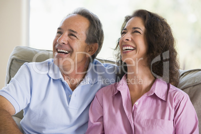 Couple relaxing in living room and laughing