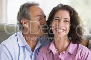 Couple relaxing in living room and smiling