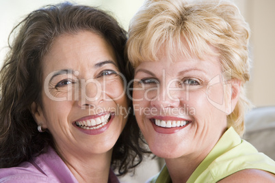 Two women in living room smiling