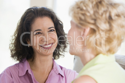 Two women in living room smiling