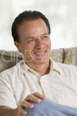 Man sitting in living room smiling