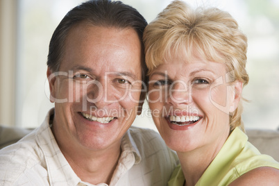 Couple relaxing in living room and smiling