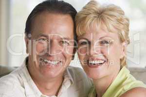 Couple relaxing in living room and smiling