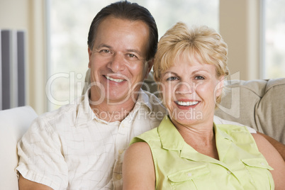 Couple relaxing in living room and smiling