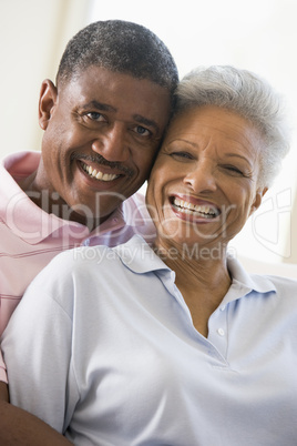 Couple relaxing in living room and smiling