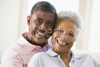 Couple relaxing in living room and smiling