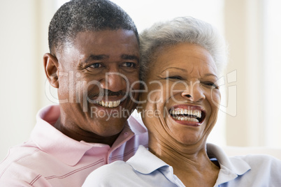Couple relaxing in living room and smiling