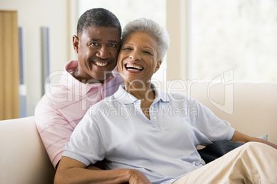 Couple relaxing in living room and smiling