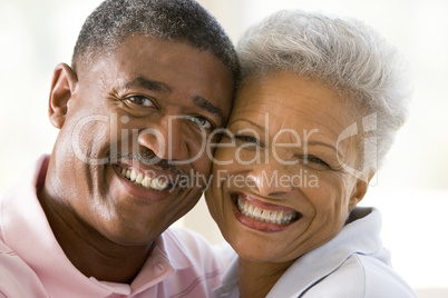 Couple relaxing indoors and smiling