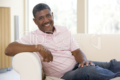 Man sitting in living room smiling