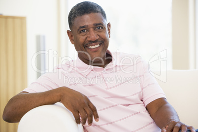 Man sitting in living room smiling