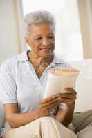 Woman relaxing with a book and smiling