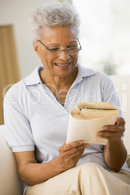 Woman relaxing with a book and smiling