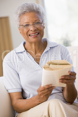 Woman relaxing with a book and smiling