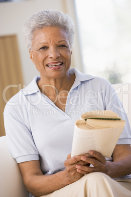 Woman relaxing with a book and smiling