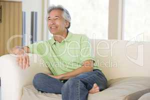 Man sitting in living room smiling