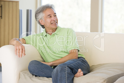 Man sitting in living room smiling