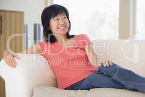 Woman relaxing in living room smiling