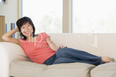 Woman relaxing in living room smiling