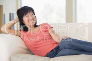 Woman relaxing in living room smiling