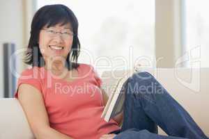 Woman relaxing with a book and smiling