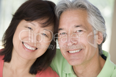 Couple relaxing indoors and smiling