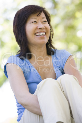 Woman sitting outdoors smiling