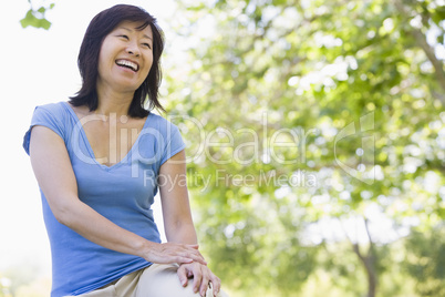 Woman sitting outdoors smiling